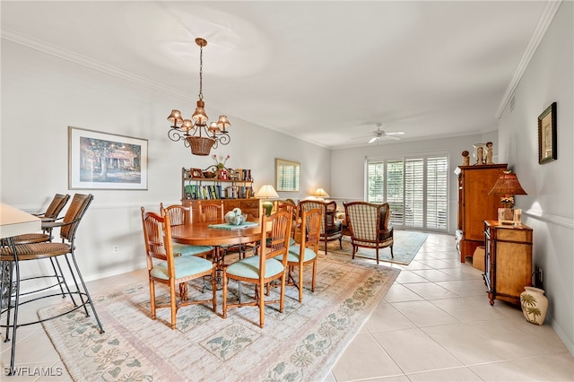 tiled dining room featuring ceiling fan with notable chandelier and ornamental molding