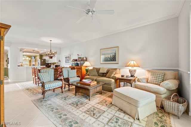 tiled living room with ceiling fan with notable chandelier and ornamental molding