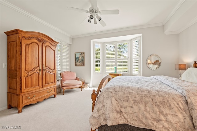 carpeted bedroom featuring ceiling fan and ornamental molding