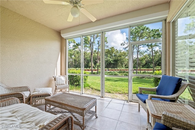 sunroom / solarium featuring ceiling fan and plenty of natural light