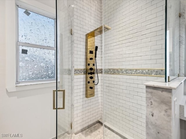 bathroom featuring a shower with door