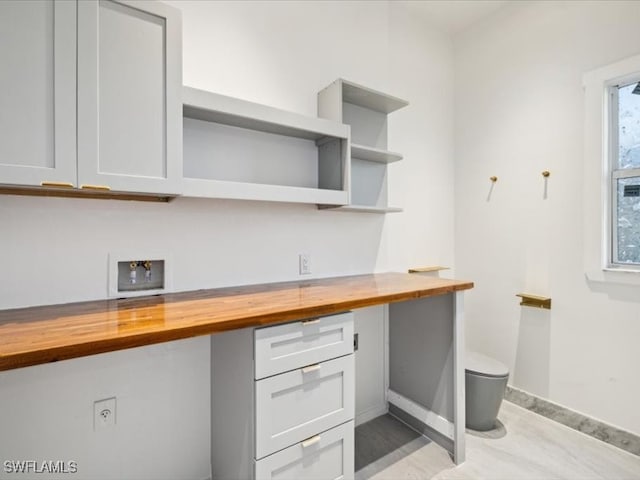 kitchen featuring built in desk, wood counters, and a wealth of natural light