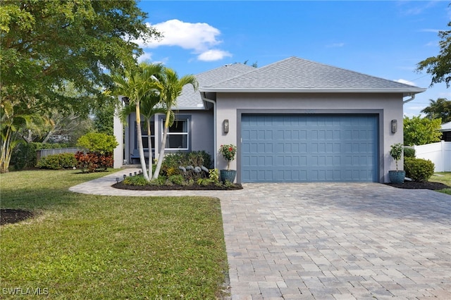 ranch-style home with a garage and a front lawn