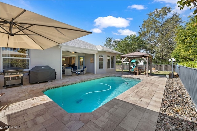 view of pool featuring outdoor lounge area, area for grilling, a gazebo, and a patio area