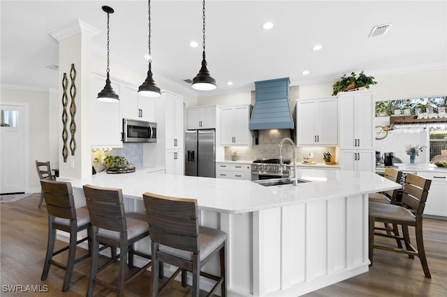 3684 Sudbury Ln, Bonita Springs, FL 34134 - kitchen featuring stainless steel appliances, premium range hood, crown molding, recessed lighting, and a breakfast bar area