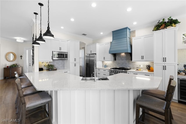 3684 Sudbury Ln, Bonita Springs, FL 34134 - kitchen with stainless steel appliances, custom exhaust hood, a breakfast bar, ornamental molding, and recessed lighting