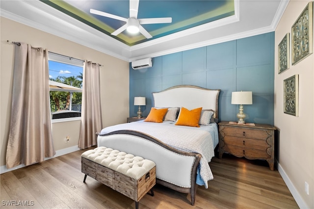 bedroom with an AC wall unit, ornamental molding, ceiling fan, and hardwood / wood-style floors