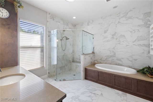 bathroom featuring independent shower and bath, vanity, and tile walls