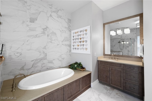 bathroom with vanity, separate shower and tub, and tile walls