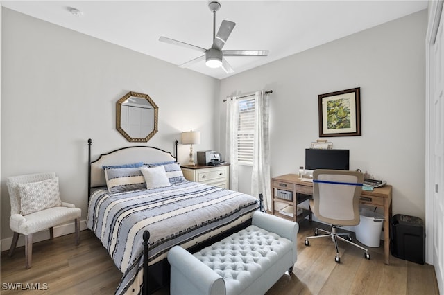 bedroom with ceiling fan and hardwood / wood-style flooring