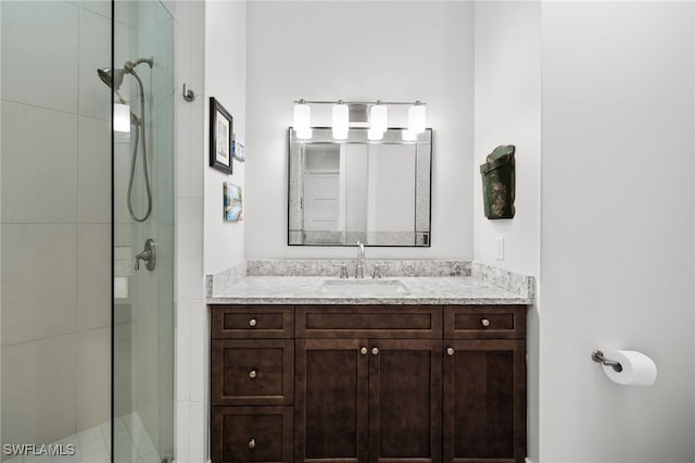 bathroom with a shower with door and vanity