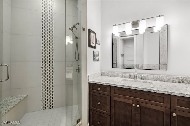 bathroom featuring vanity and a shower with door