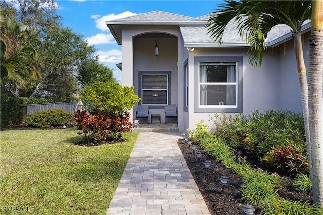 3684 Sudbury Ln, Bonita Springs, FL 34134 - property entrance with stucco siding, a shingled roof, and covered porch