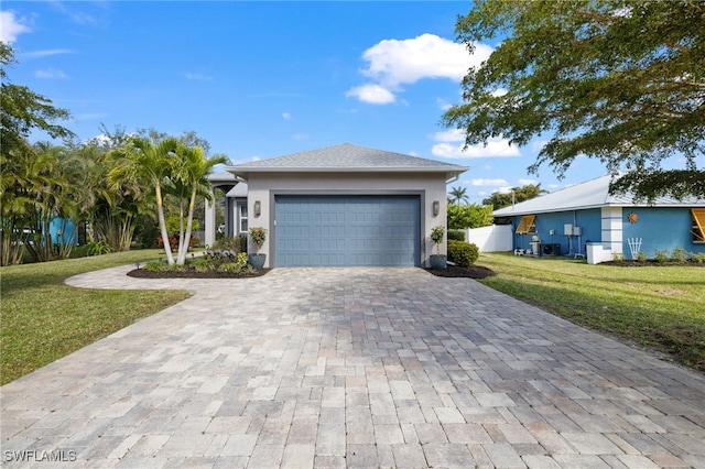 3684 Sudbury Ln, Bonita Springs, FL 34134 - view of front of home with decorative driveway, a front lawn, a garage, and stucco siding