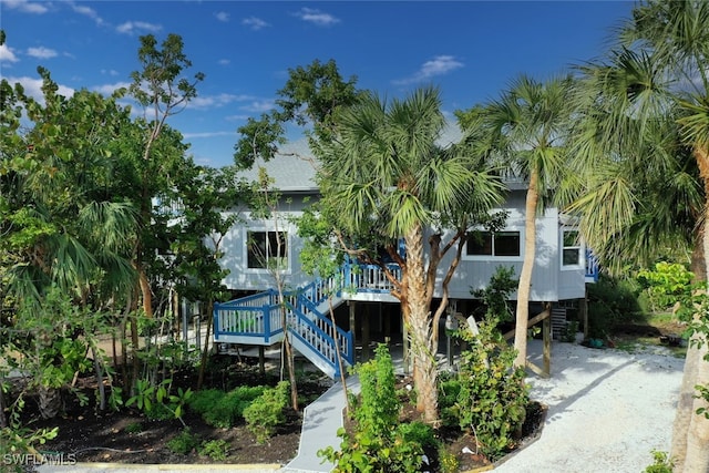 back of house featuring a carport