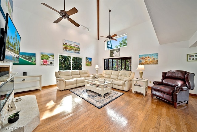 living room featuring high vaulted ceiling, light wood-type flooring, and ceiling fan