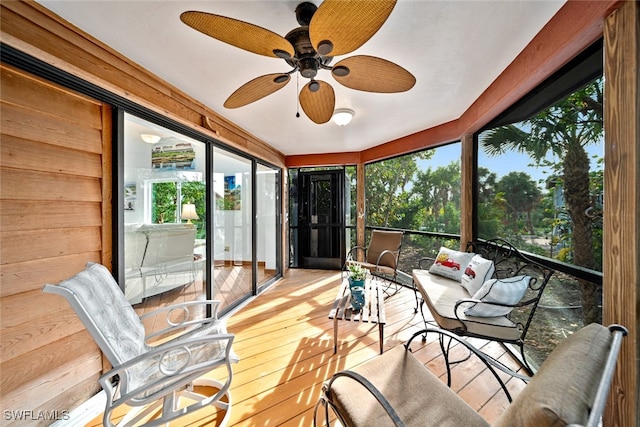 sunroom / solarium featuring ceiling fan and a wealth of natural light