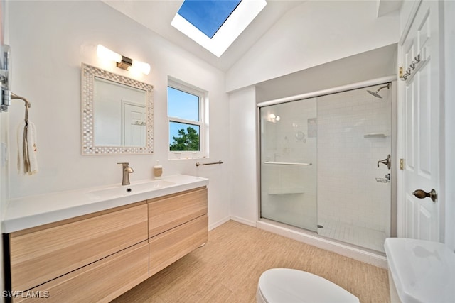 bathroom with vanity, hardwood / wood-style floors, lofted ceiling with skylight, toilet, and a shower with door