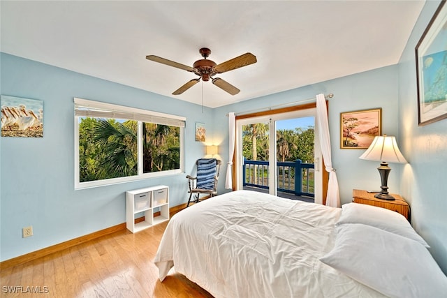 bedroom featuring light hardwood / wood-style flooring, ceiling fan, and access to outside