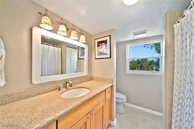 bathroom featuring tile patterned flooring, vanity, and toilet