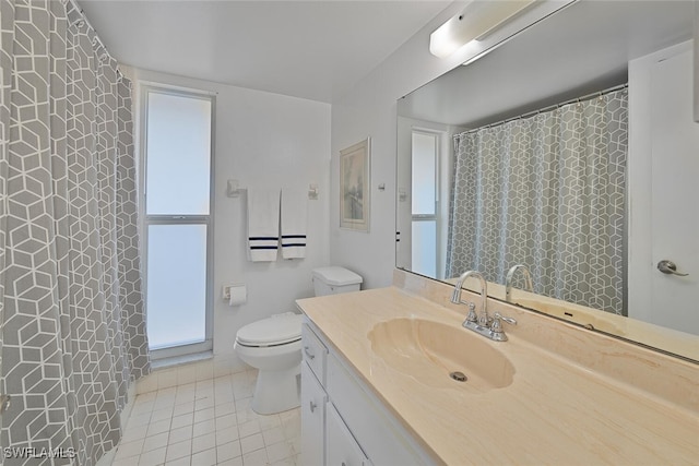 bathroom with tile patterned flooring, vanity, and toilet