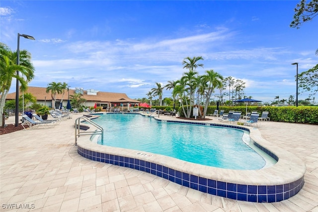 view of swimming pool featuring a patio area