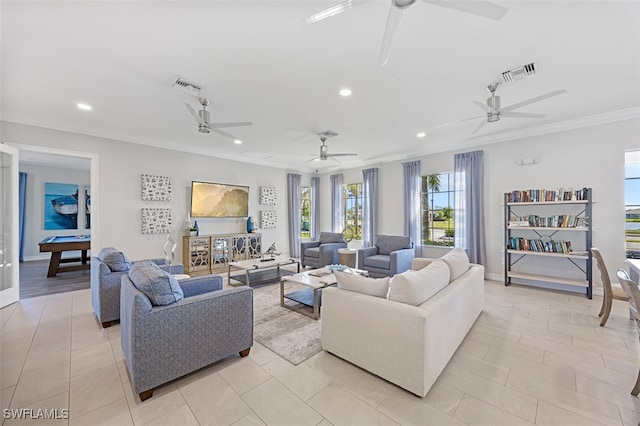 living room with light tile patterned floors and ornamental molding