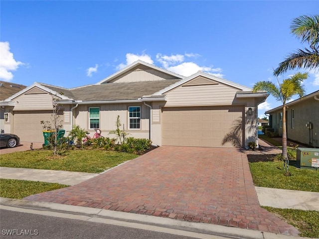 ranch-style home with a front yard and a garage