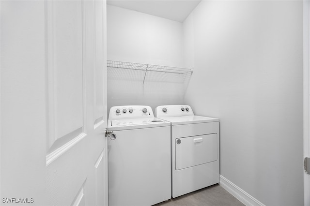 washroom featuring washing machine and clothes dryer