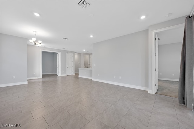 empty room featuring an inviting chandelier and sink