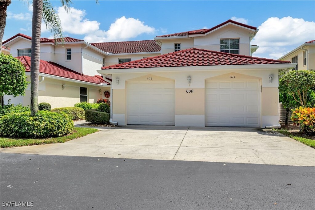 mediterranean / spanish-style home with a garage