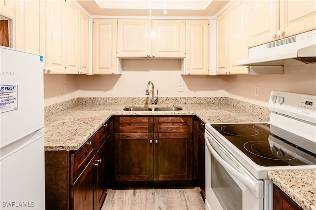 kitchen featuring light stone counters, white cabinets, white appliances, dark brown cabinetry, and sink