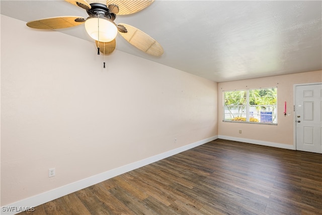 empty room featuring dark hardwood / wood-style flooring and ceiling fan