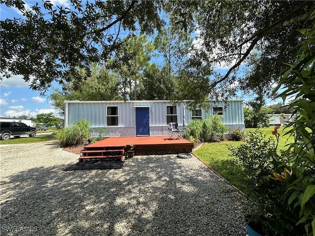 manufactured / mobile home with a front yard and a deck