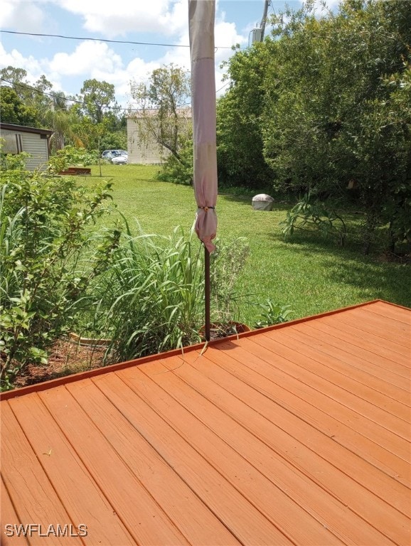 wooden terrace with a yard