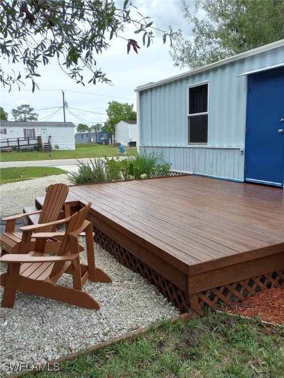 wooden terrace with a yard