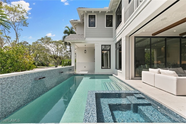 view of swimming pool with an outdoor hangout area and a pool with connected hot tub