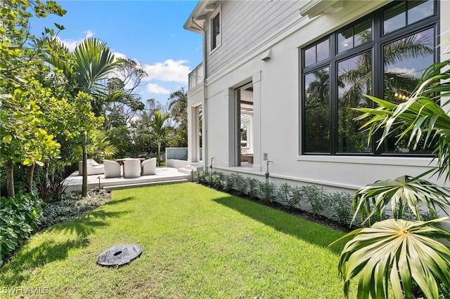 view of yard with outdoor lounge area and a patio