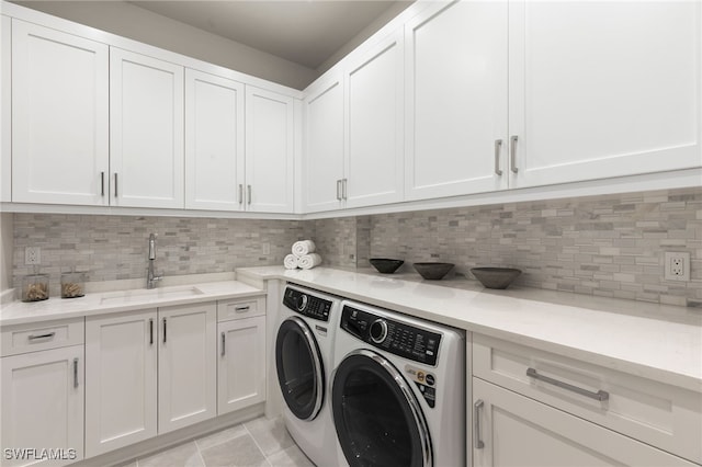 laundry area with a sink, cabinet space, and independent washer and dryer