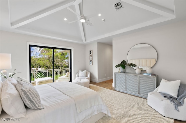bedroom with ceiling fan, access to exterior, wood finished floors, vaulted ceiling, and visible vents