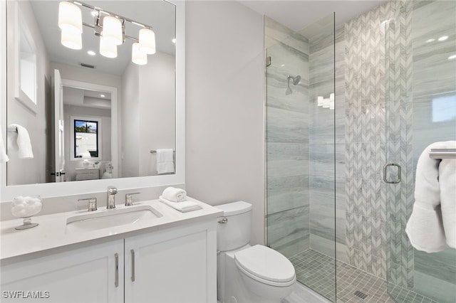 full bath with vanity, a shower stall, toilet, and visible vents