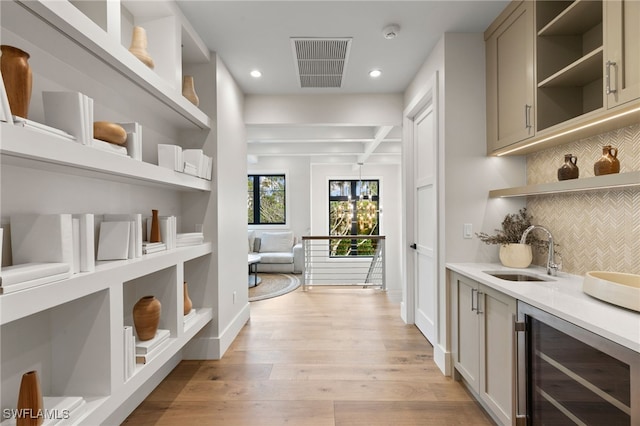 interior space with beverage cooler, visible vents, and a sink