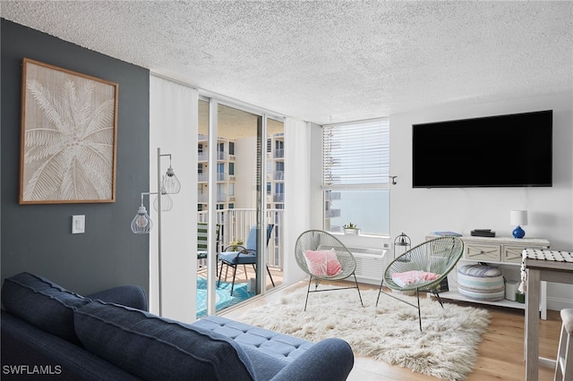 living room featuring a textured ceiling and hardwood / wood-style flooring