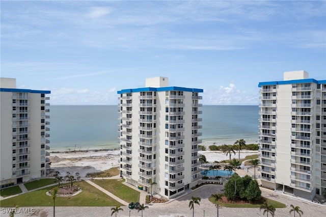 view of property featuring a view of the beach and a water view