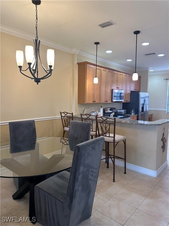 dining room featuring crown molding, light tile patterned flooring, and a notable chandelier