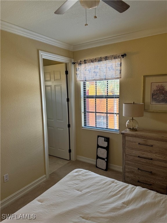 bedroom with ceiling fan, carpet flooring, and ornamental molding