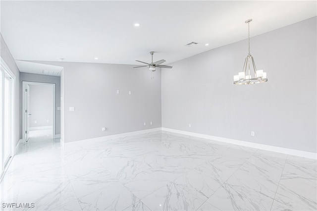 unfurnished room featuring ceiling fan with notable chandelier