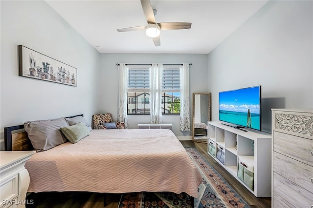 bedroom with dark hardwood / wood-style flooring and ceiling fan