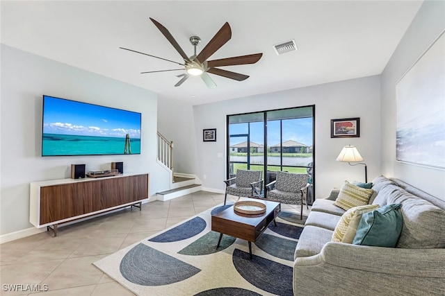 living room featuring ceiling fan and light tile patterned flooring