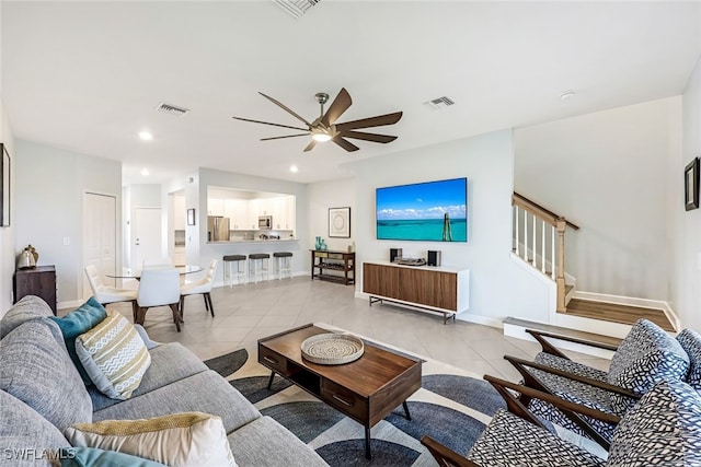 tiled living room with ceiling fan